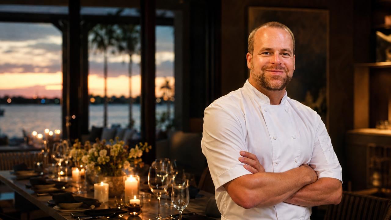 Chef Mark Lorenz beside an elegantly set candlelit dining table